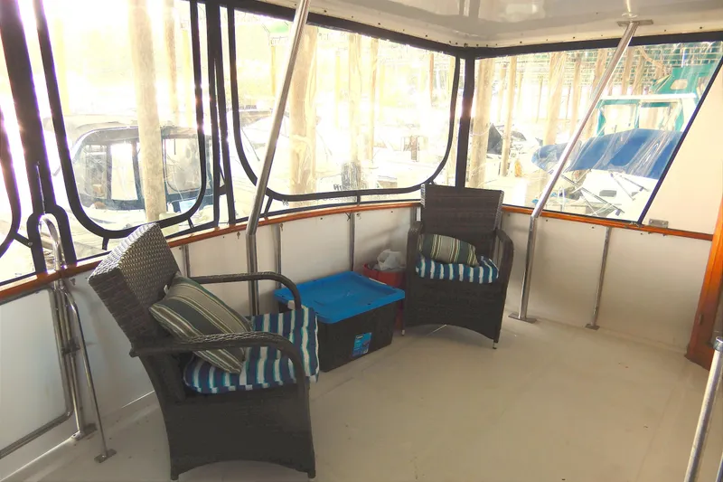 Slide: The Image of Enclosed deck of 1989 Jefferson 46 Sundeck yacht with wicker chairs and cushions. - 6