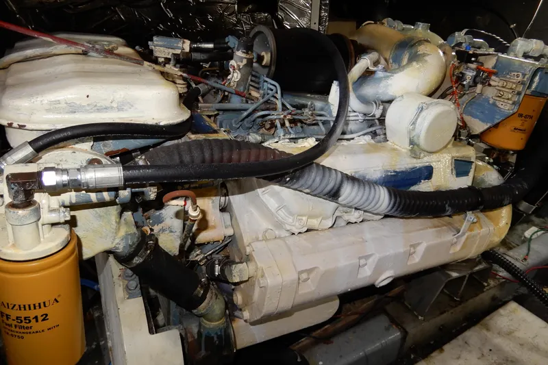 Slide: The Image of Engine compartment of a 1989 Jefferson 46 Sundeck boat, showing detailed mechanical components. - 61