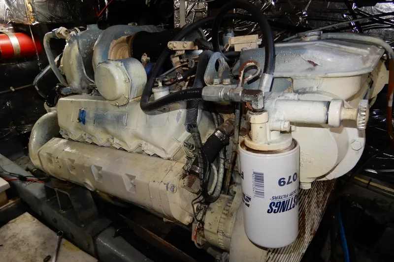 Slide: The Image of Engine of a 1989 Jefferson 46 Sundeck boat, featuring detailed mechanical components. - 63