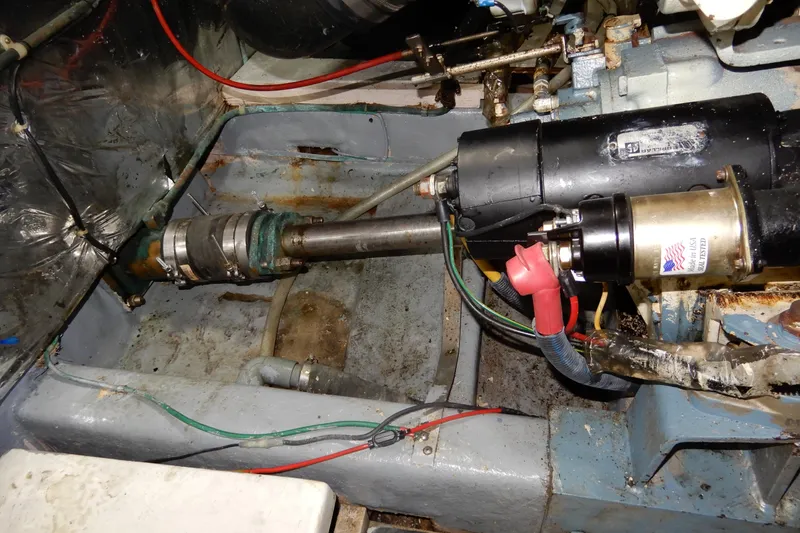 Slide: The Image of Engine compartment of 1989 Jefferson 46 Sundeck boat, showing mechanical components and wiring. - 64