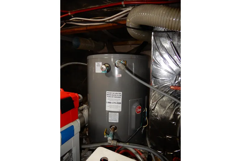 Slide: The Image of 1989 Jefferson 46 Sundeck boat engine room with Rheem water heater and ventilation ducts. - 66
