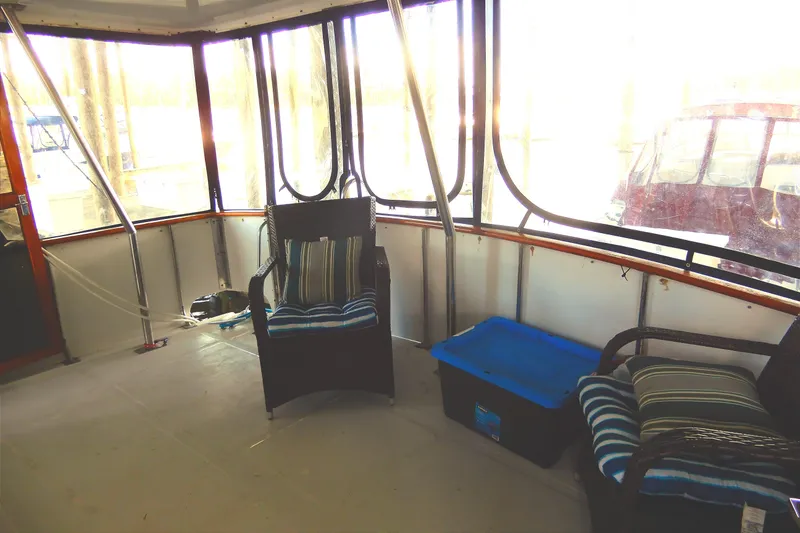 Slide: The Image of 1989 Jefferson 46 Sundeck interior with wicker chairs and striped cushions. - 7