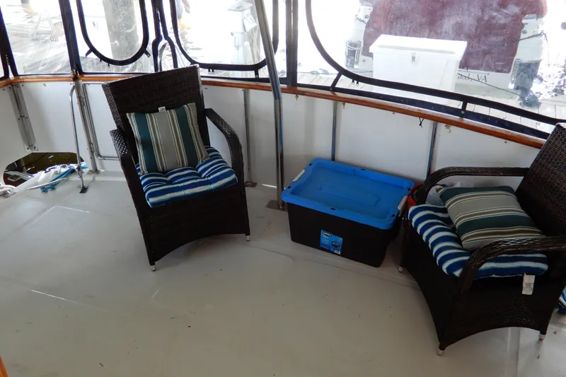 Slide: The Image of 1989 Jefferson 46 Sundeck interior with wicker chairs and storage box. - 9