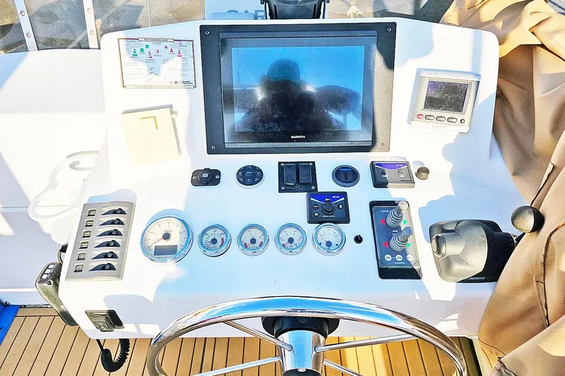 Slide: The Image of Helm of 2010 Eastern Casco Bay 35 with navigation controls and gauges. - 12