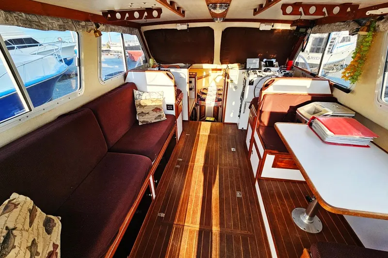 Slide: The Image of Interior of 2010 Eastern Casco Bay 35 boat with cozy seating and wooden flooring. - 13