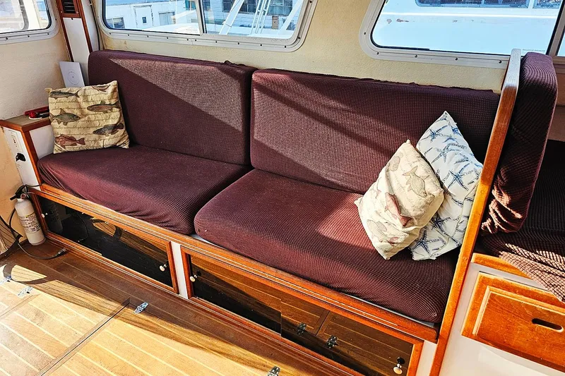Slide: The Image of Interior of 2010 Eastern Casco Bay 35 with maroon seating and decorative pillows. - 14