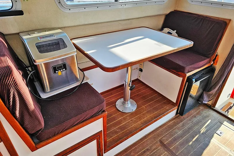 Slide: The Image of Interior of 2010 Eastern Casco Bay 35 with table, seating, and ice maker. - 15