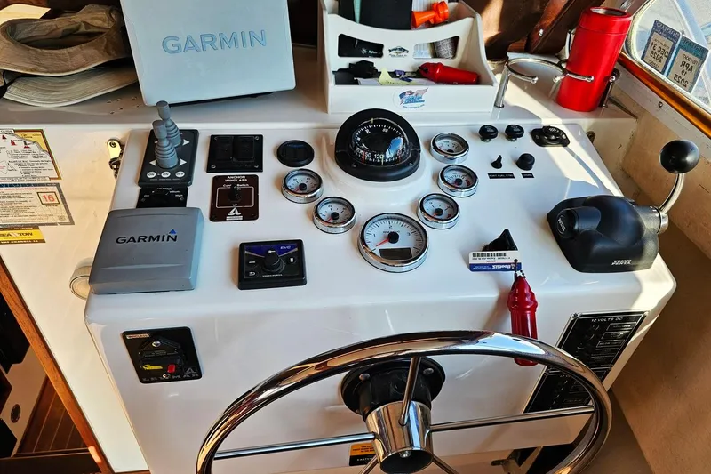 Slide: The Image of Control panel of a 2010 Eastern Casco Bay 35 boat with Garmin navigation equipment. - 17