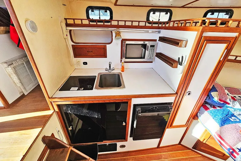 Slide: The Image of Compact kitchen in 2010 Eastern Casco Bay 35 boat with sink, stove, and microwave. - 19