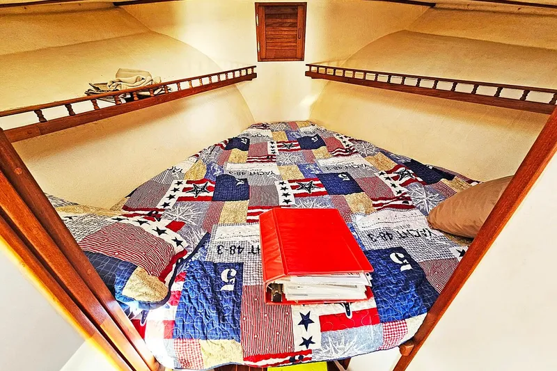 Slide: The Image of Cozy cabin interior of 2010 Eastern Casco Bay 35 with colorful quilted bedding. - 21