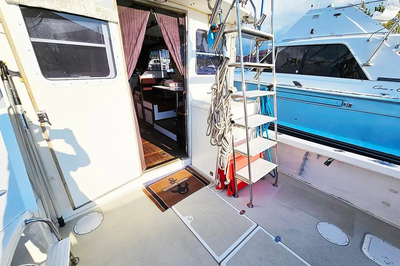 Slide: The Image of 2010 Eastern Casco Bay 35 boat deck with ladder and open cabin door. - 5