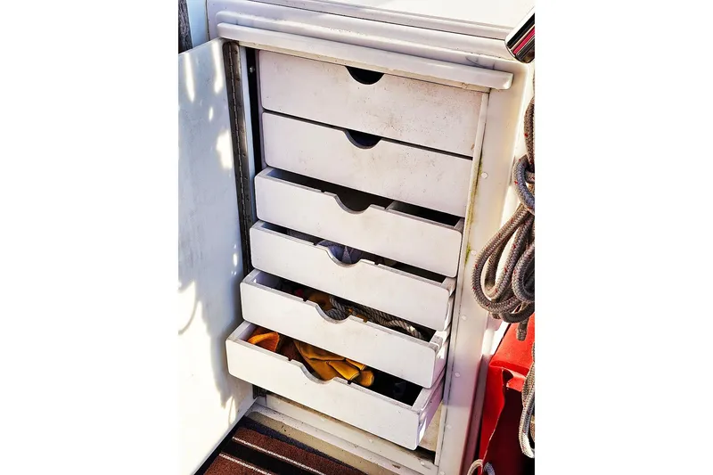 Slide: The Image of Storage drawers on 2010 Eastern Casco Bay 35 boat, with ropes and tools visible. - 6