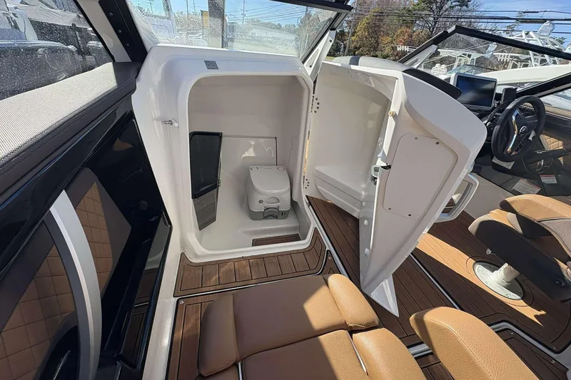 Slide: The Image of 2024 Yamaha 275 SD boat interior with open storage compartment and seating area. - 12