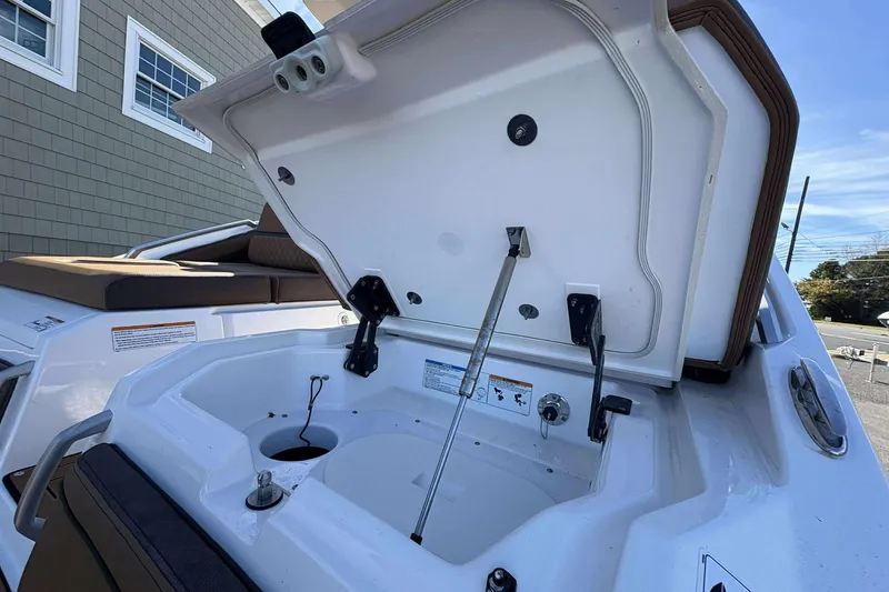 Slide: The Image of Open storage compartment on 2024 Yamaha 275 SD boat, showcasing interior features. - 17