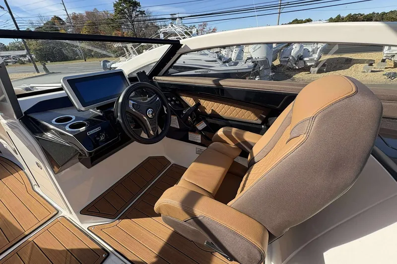 Slide: The Image of 2024 Yamaha 275 SD boat interior with modern dashboard and luxurious seating. - 8