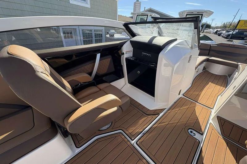 Slide: The Image of 2024 Yamaha 275 SD boat interior with luxurious seating and wood-style flooring. - 9