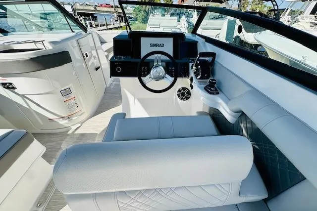 Slide: The Image of 2025 Sea Ray SDX 290 Outboard helm with modern controls and luxurious seating. - 10