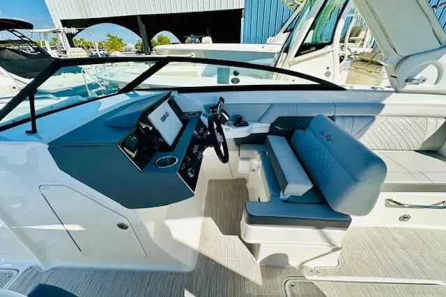 Slide: The Image of 2025 Sea Ray SDX 290 Outboard boat interior with modern helm and seating. - 12