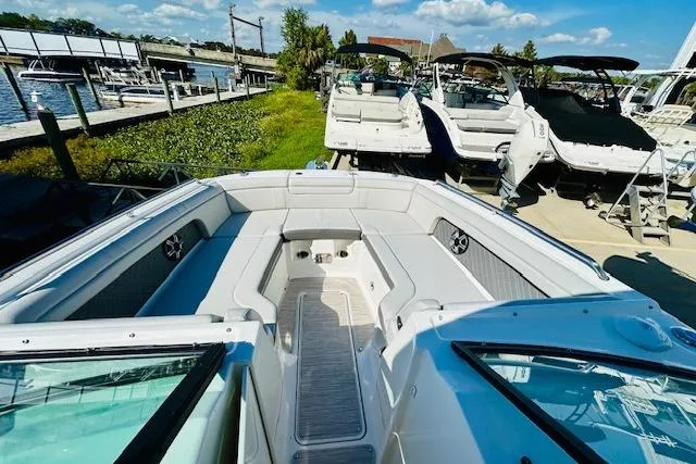 Slide: The Image of 2025 Sea Ray SDX 290 Outboard boat docked, showcasing spacious seating and sleek design. - 15