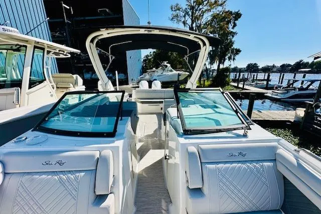 Slide: The Image of 2025 Sea Ray SDX 290 Outboard boat docked, showcasing luxurious seating and sleek design. - 19