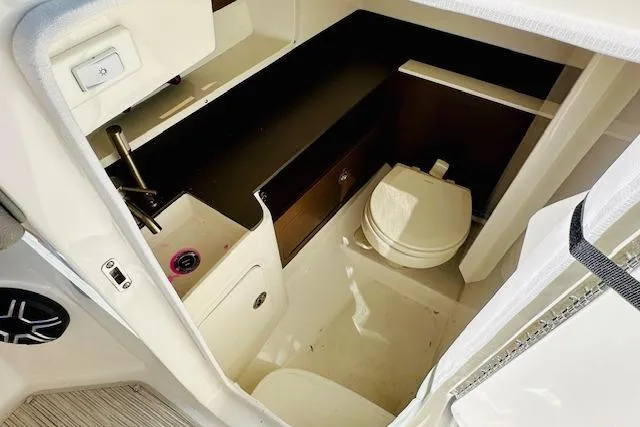 Slide: The Image of 2025 Sea Ray SDX 290 Outboard boat interior with compact bathroom amenities. - 21
