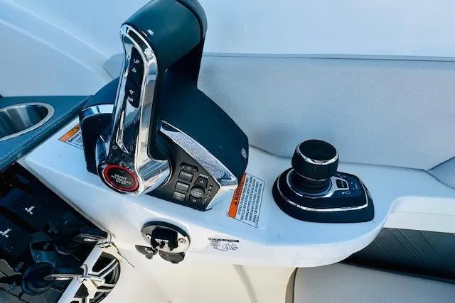 Slide: The Image of 2025 Sea Ray SDX 290 Outboard control panel with throttle and joystick. - 22