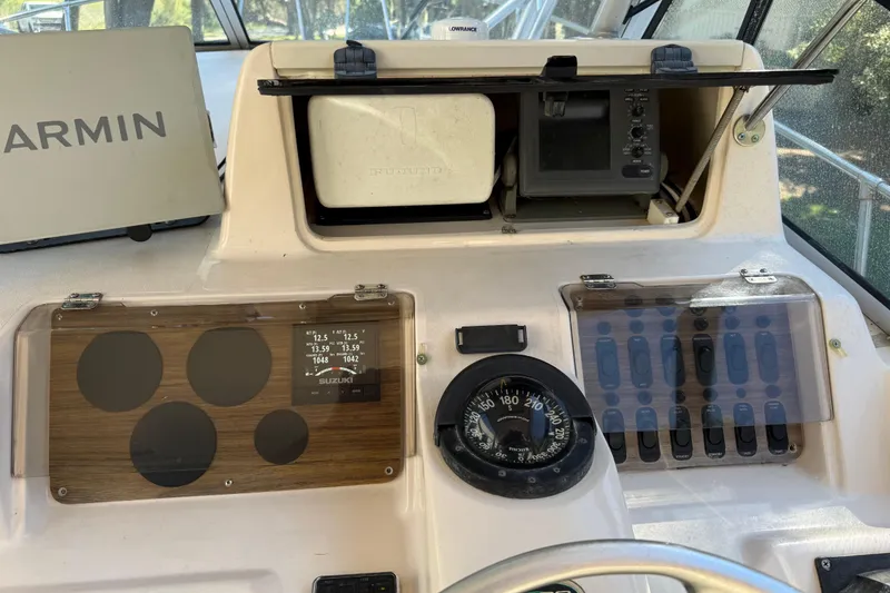 Slide: The Image of 1998 Grady-White Marlin 300 boat dashboard with Garmin and Furuno navigation equipment. - 11