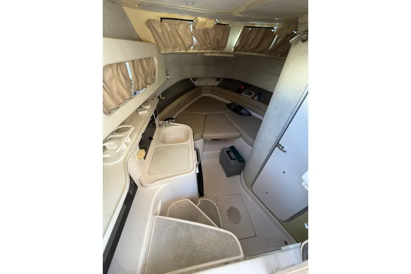 Slide: The Image of 1998 Grady-White Marlin 300 cabin interior with seating, sink, and storage. - 13