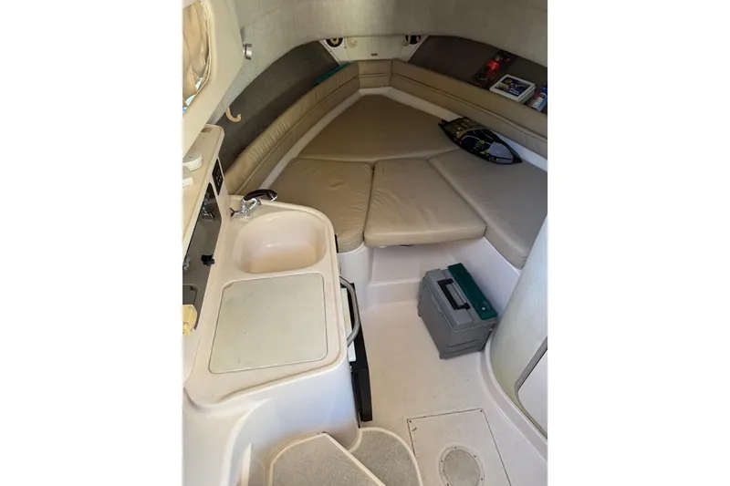 Slide: The Image of 1998 Grady-White Marlin 300 cabin interior with seating, sink, and storage. - 14