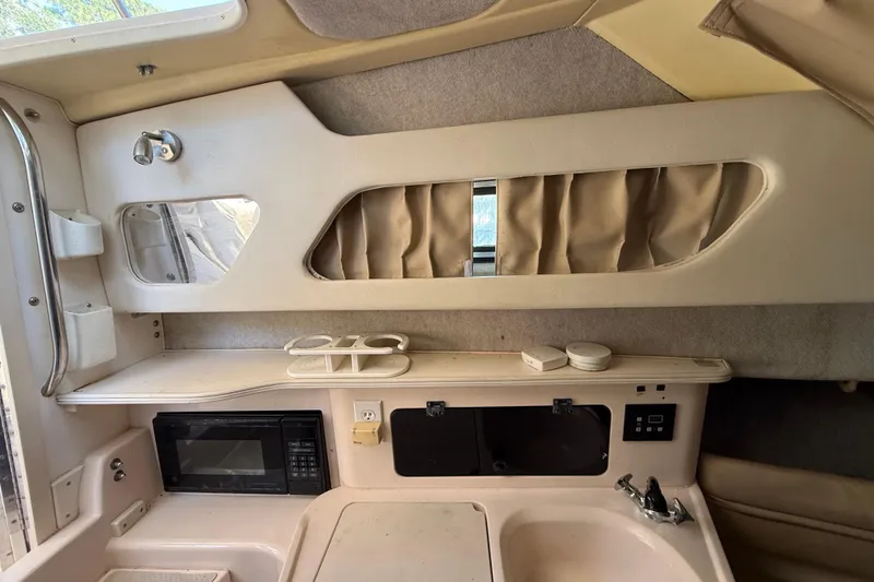 Slide: The Image of Interior of a 1998 Grady-White Marlin 300 boat with kitchenette and storage. - 17