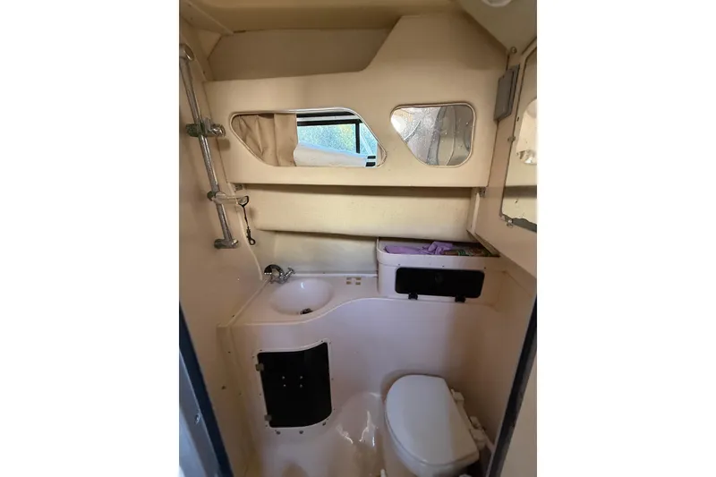 Slide: The Image of 1998 Grady-White Marlin 300 boat bathroom with sink, toilet, and storage. - 19