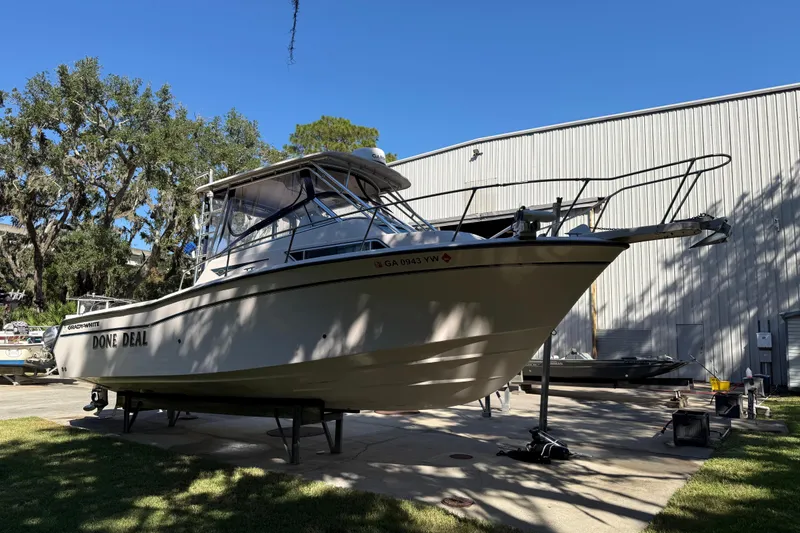 Slide: The Image of 1998 Grady-White Marlin 300 boat on stands, outdoors near a metal building. - 2