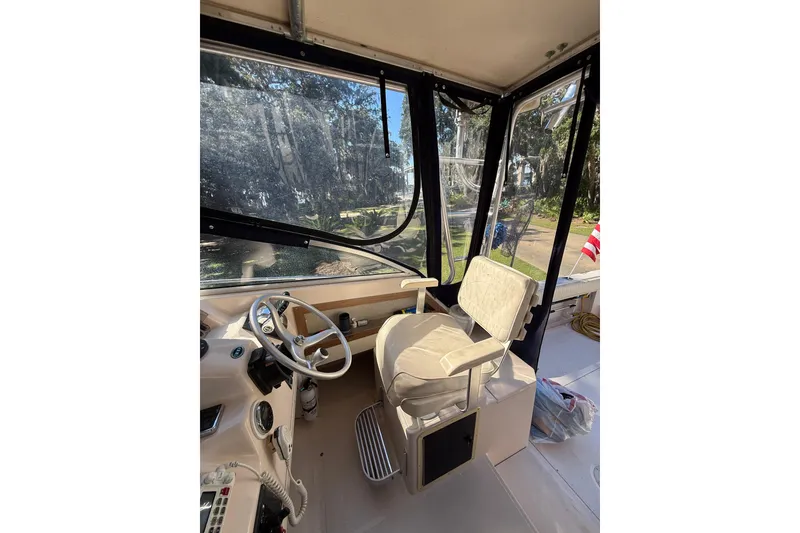 Slide: The Image of 1998 Grady-White Marlin 300 boat interior with steering wheel and captain's chair. - 20