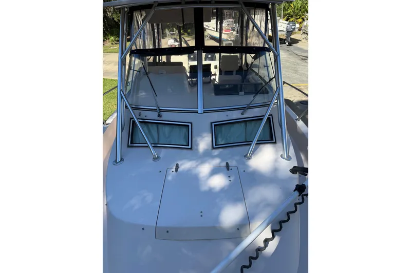 Slide: The Image of 1998 Grady-White Marlin 300 boat, front view with windshield and metal framework. - 24