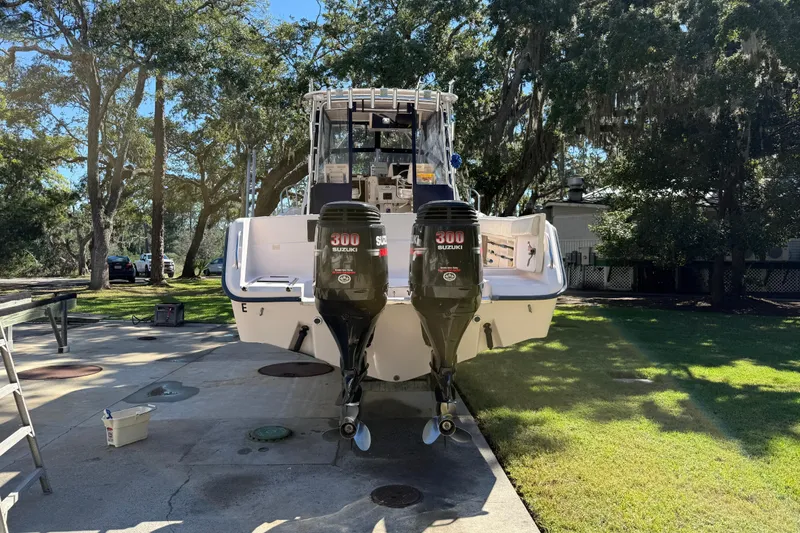 Slide: The Image of 1998 Grady-White Marlin 300 boat with twin Suzuki 300 engines, parked outdoors. - 7