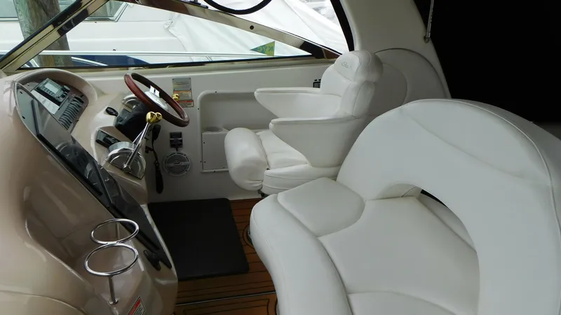 Slide: The Image of 2002 Sea Ray 380 Sundancer helm with white seating and wood accents. - 11