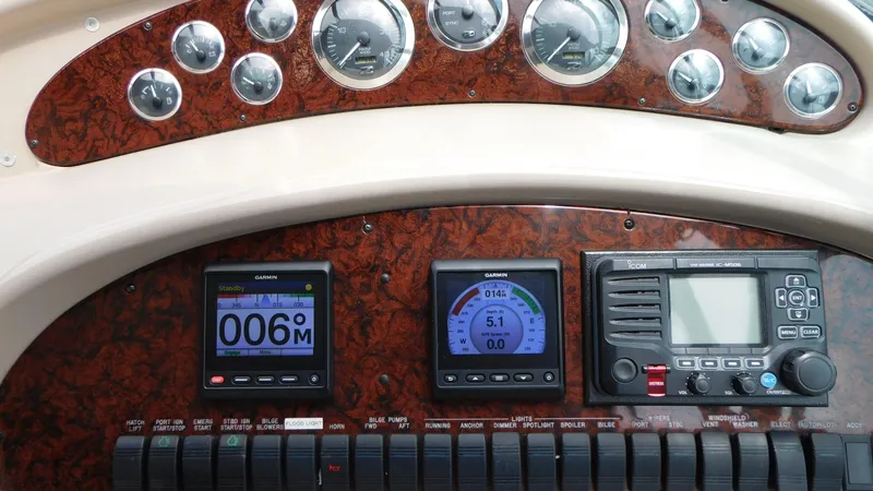Slide: The Image of Control panel of a 2002 Sea Ray 380 Sundancer boat with gauges and navigation instruments. - 13