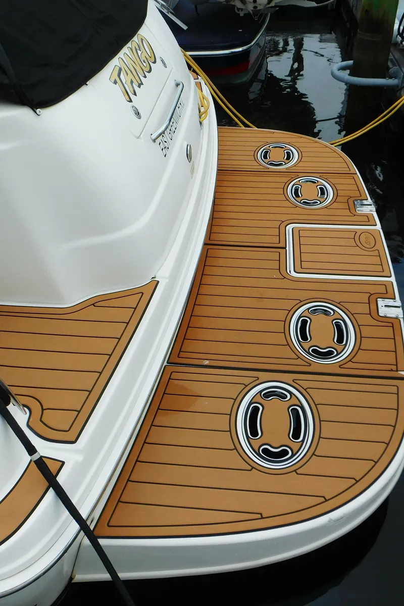 Slide: The Image of 2002 Sea Ray 380 Sundancer swim platform with teak finish and mooring cleats. - 3