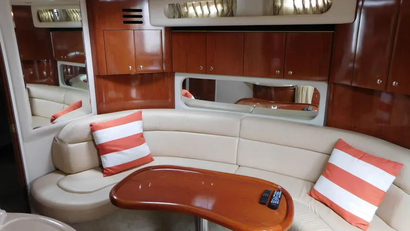 Slide: The Image of Luxurious interior of 2002 Sea Ray 380 Sundancer with plush seating and wooden accents. - 32