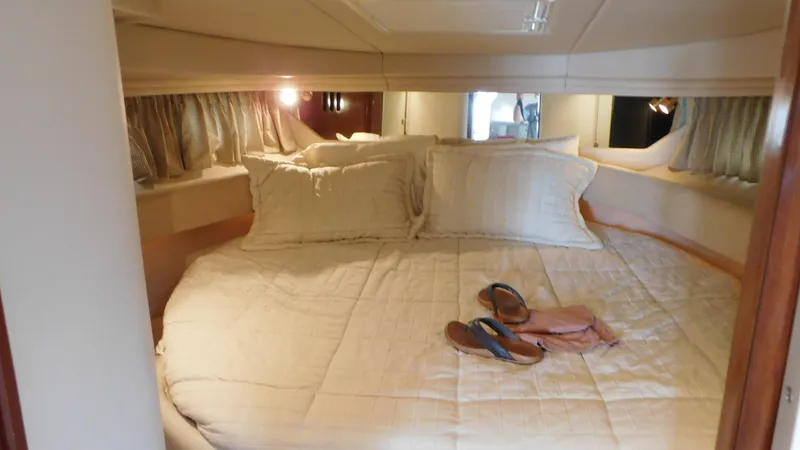 Slide: The Image of Cozy cabin interior of 2002 Sea Ray 380 Sundancer with a neatly made bed. - 36
