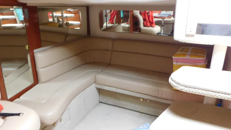 Slide: The Image of 2002 Sea Ray 380 Sundancer interior with beige leather seating and mirrors. - 39