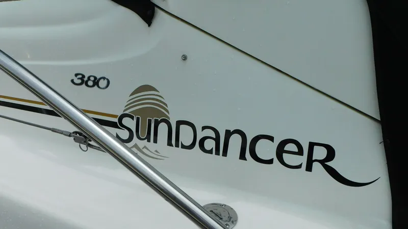 Slide: The Image of 2002 Sea Ray 380 Sundancer boat logo on white surface. - 4