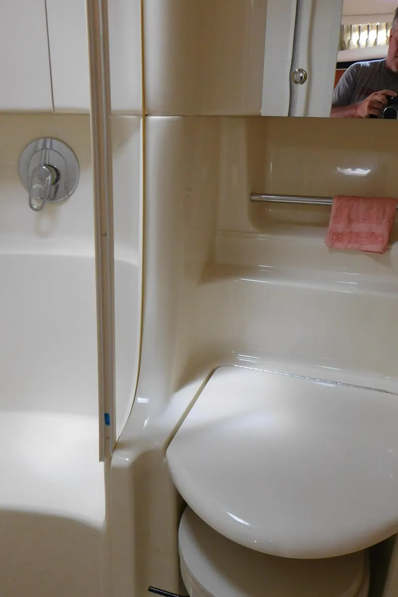 Slide: The Image of Bathroom interior of 2002 Sea Ray 380 Sundancer yacht, featuring shower and toilet. - 42