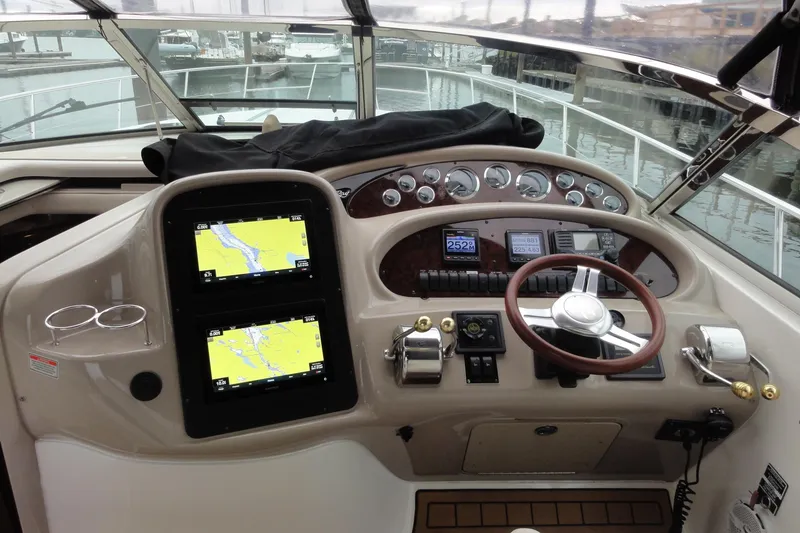Slide: The Image of Helm of 2002 Sea Ray 380 Sundancer with navigation screens and controls. - 50
