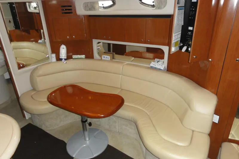 Slide: The Image of Luxurious interior of 2002 Sea Ray 380 Sundancer with beige leather seating and wooden table. - 59