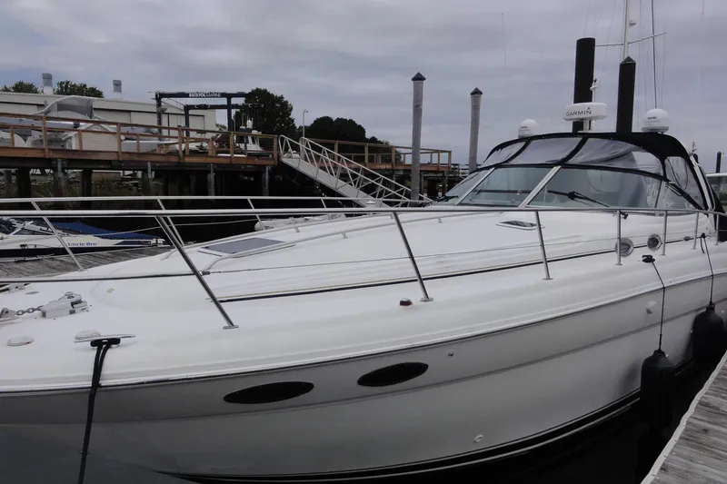 Slide: The Image of 2002 Sea Ray 380 Sundancer yacht docked at marina under cloudy sky. - 60