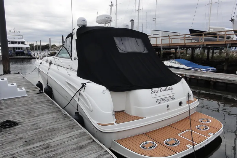 Slide: The Image of 2002 Sea Ray 380 Sundancer yacht docked at marina with black cover. - 63