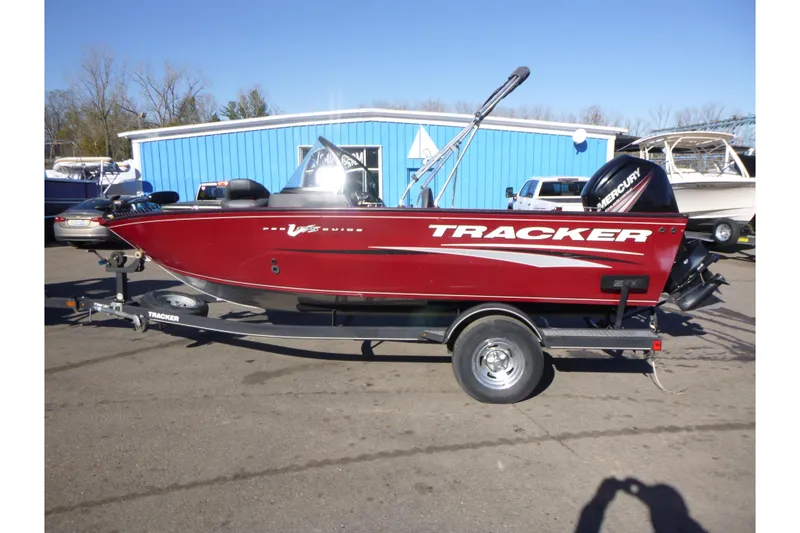 The Image of 2019 Tracker Pro Guide V-175 WT boat on trailer, red exterior, parked outdoors. - 0