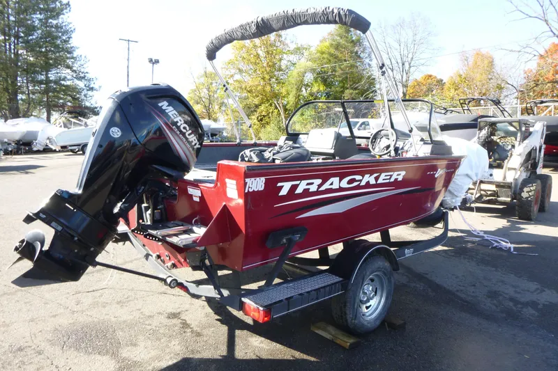 Slide: The Image of 2019 Tracker Pro Guide V-175 WT boat on trailer, red exterior, parked outdoors. - 3