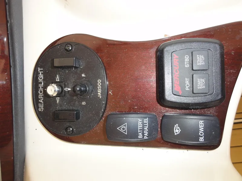 Slide: The Image of Control panel of a 2009 Meridian 441 Sedan boat with searchlight and blower switches. - 23